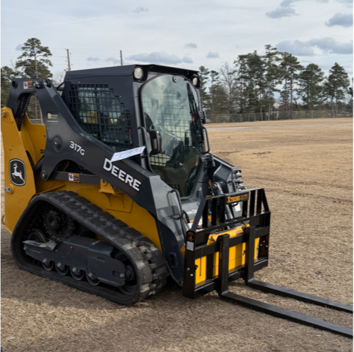 XTREME DUTY skid steer pallet forks mounted on a John Deere compact track loader