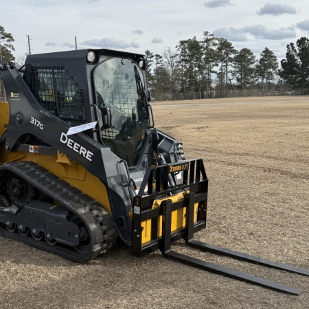 XTREME DUTY skid steer pallet forks mounted on a John Deere compact track loader